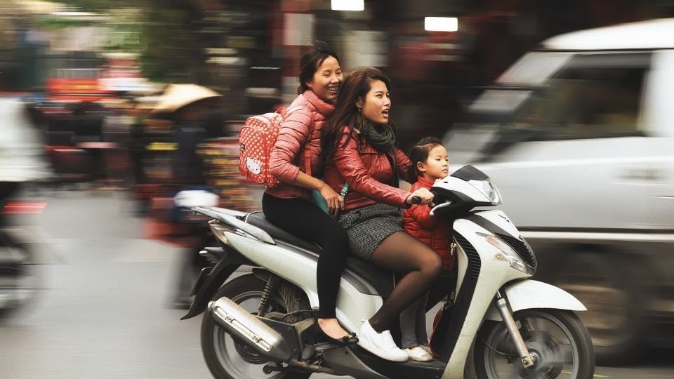 asian women on a scooter from paolo candelo on unsplash compressor