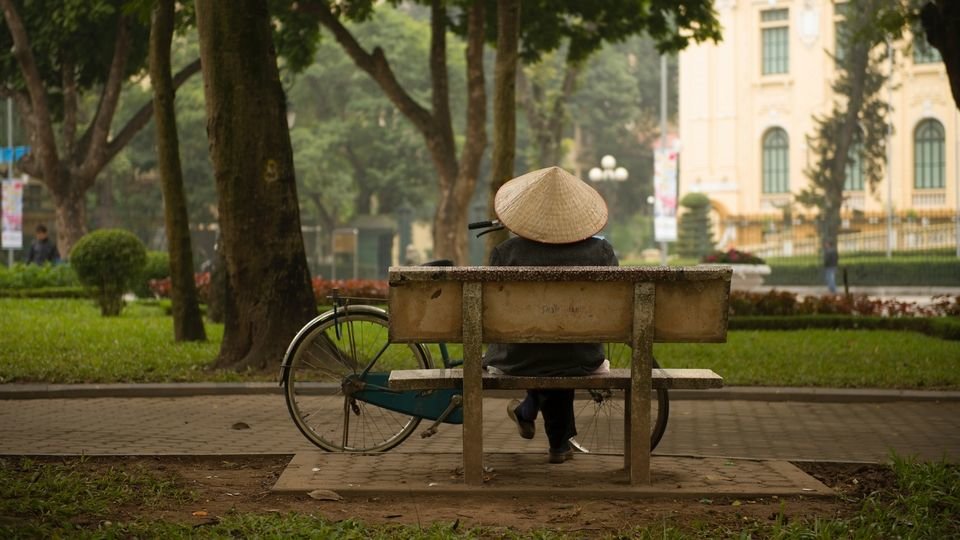 vietnamese woman sitting on a bench by lukasz saczek on unsplash compressor