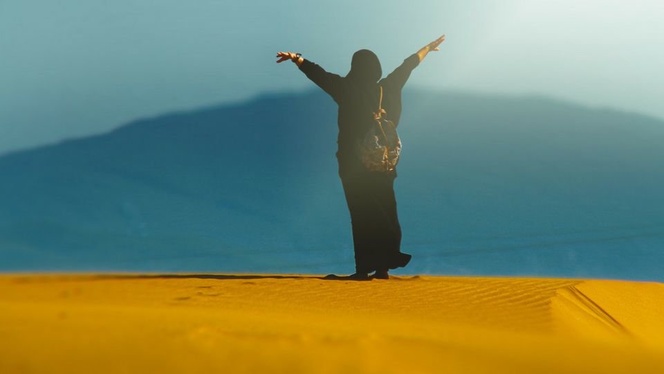 woman raising hands from unsplash by mohamed nohassi compressor
